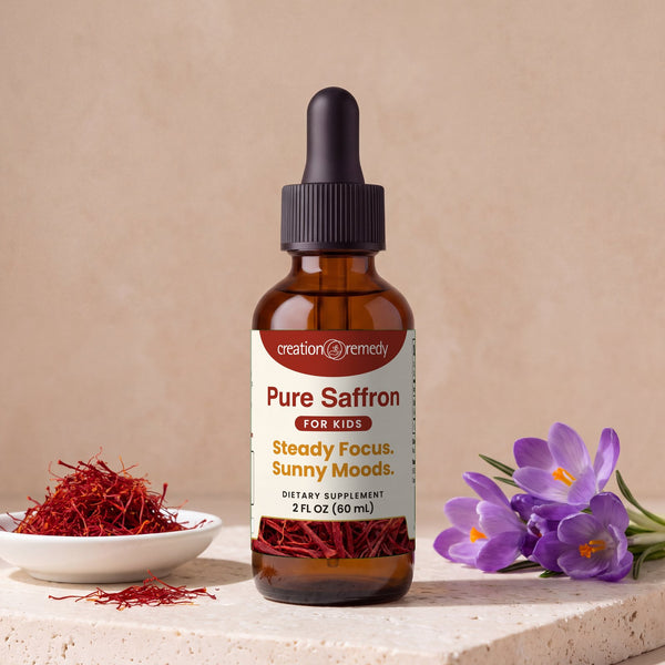 Pure Saffron drops beside a dish of saffron threads and purple crocus flowers