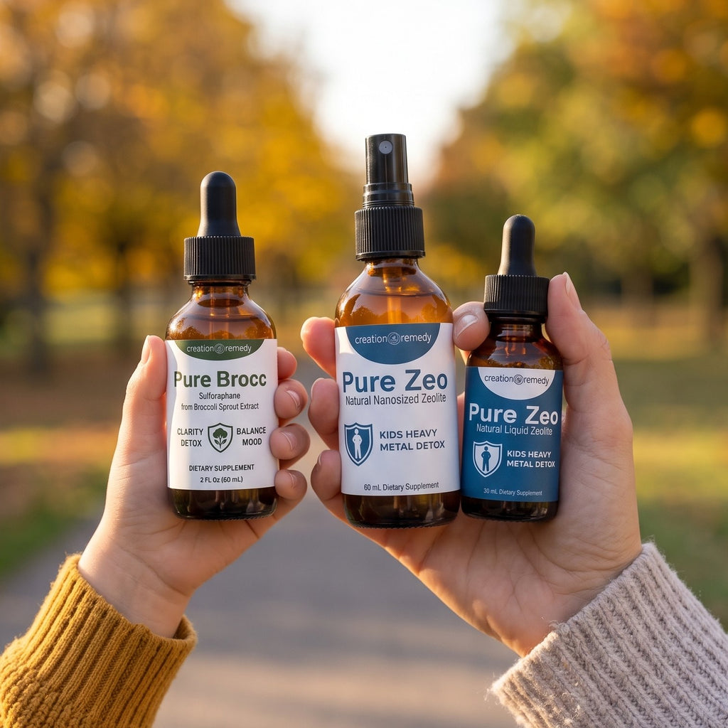 A mom&rsquo;s hand holding Pure Zeo spray and drops and a child&rsquo;s hand holding Pure Brocc in a park in the fall