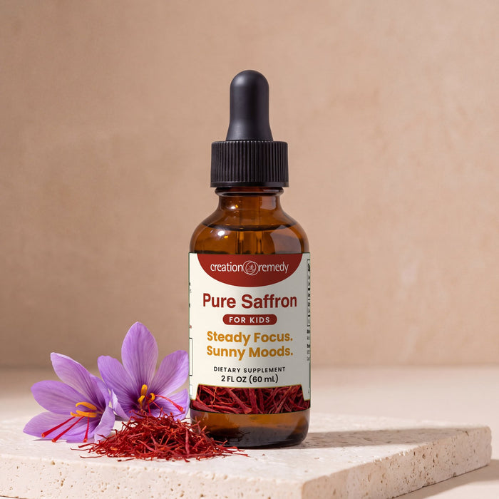Pure Saffron drops beside a small heap of saffron threads and purple crocus flowers
